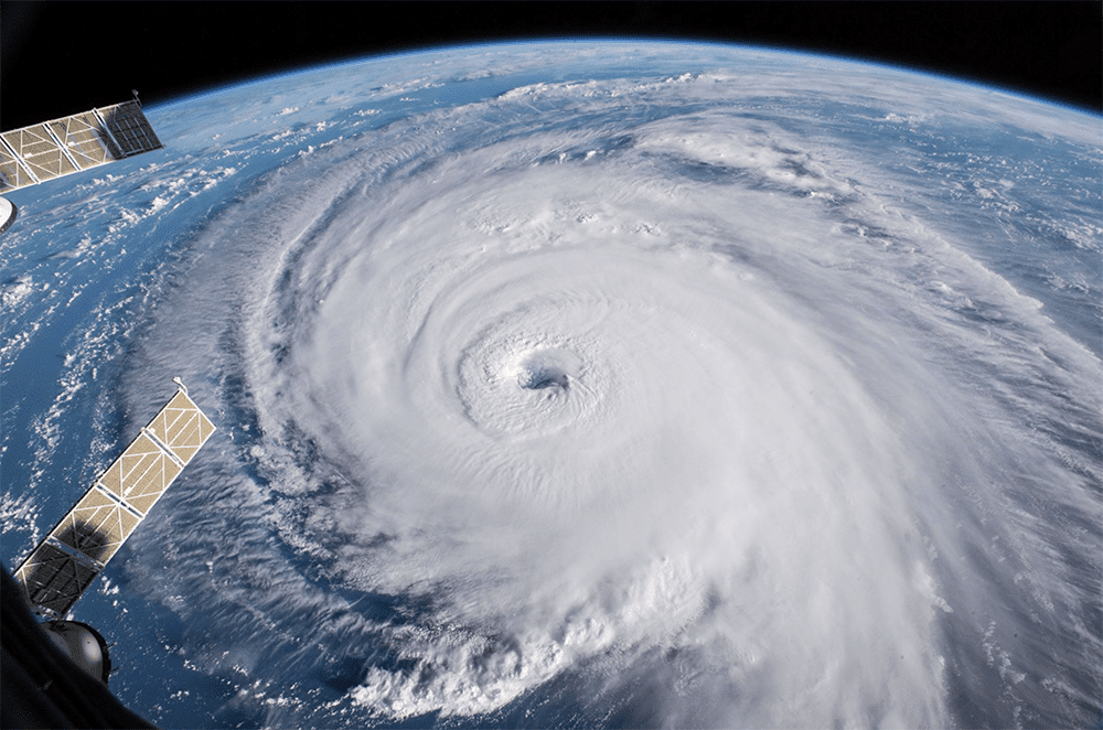 A photo of Cyclone Larry from space. The storm is a big white spinning shape.
